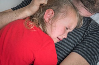 Üzgün çocuk babasının göğsünde ağlıyor - aile kavramı