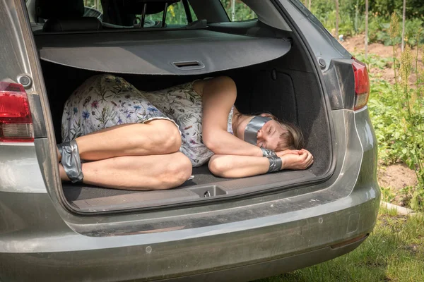Woman with tied hands inside car trunk - kidnapping