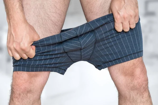 Man Puts Undressing His Underpants — Stock Photo, Image