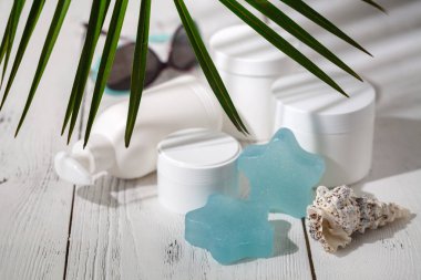 Kozmetik şişe kapları ile yeşil bitki yaprakları, marka mock-up, doğal organik güzellik ürün kavramı için boş etiket paketi