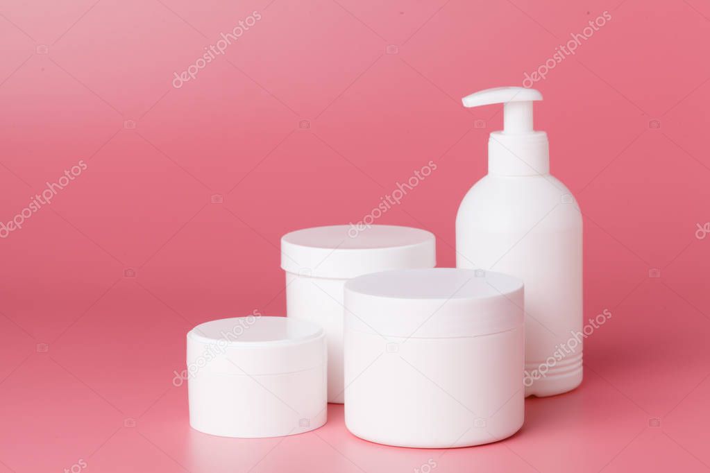 Round packaging of cream. Jar of cream isolated on pink background