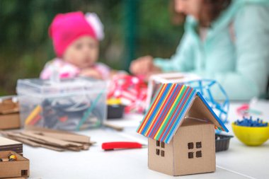 Yaratıcı çocuklar el sanatları ile oynamak. Sevimli okul öncesi çocukları birlikte kağıt dekor hazırlamak. Çocuk sanat yaratıcılık Caddesi üzerinde tablo için malzeme ve araçları