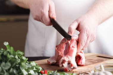 Şef kasap kesim kuzu eti ile mutfak, bıçakta hasta yemek yemek