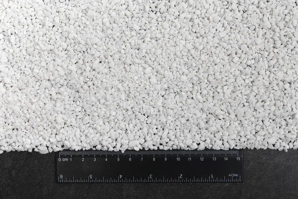 Macro shot of mixed chemical, artificial nitrogen plant fertilizer granules in factory. Big heaps of mineral pellets