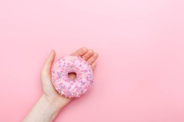 Pastel pembe arka planda kremalı çörekler. Tatlı çörekler.