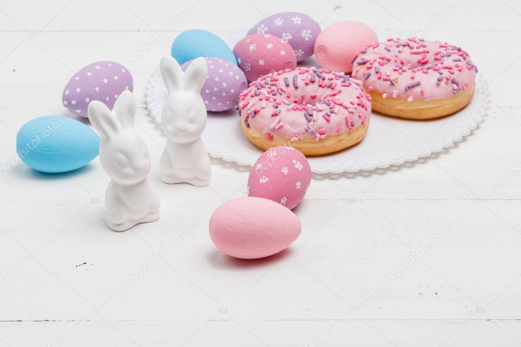 Easter Eggs Over Wooden Background with bunnies