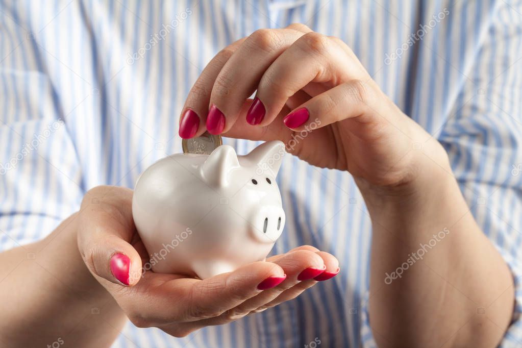 Save money concept, Piggy bank in a human hand