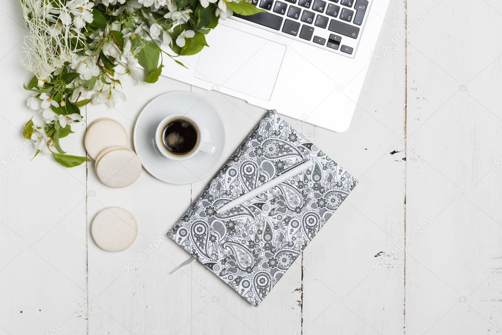 Modern feminine workplace concept. Laptop, coffee, beautiful app