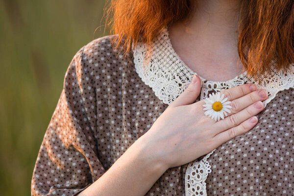 close-up, hands of a girl who plays in the grass on a summer meadow
