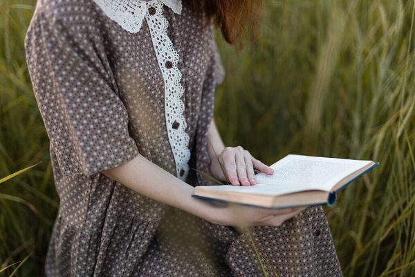 close-up, hands of a girl who plays in the grass on a summer meadow