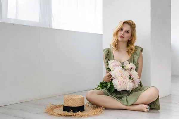 실내에서 흰색과 향기를 아름다운 소녀가 꽃다발을 즐기며 — 스톡 사진