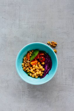 Vegan energy boosting buddha bowl. Flat-lay of chickpeas, spinach, tomatoes, red cabbage, walnuts on light background. Clean eating, superfood, vegan, detox food concept. Top view clipart