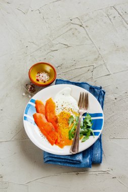 Fried eggs with smoked salmon - healthy diet breakfast on a light concrete background side view. Good fats healthy eating concept. Flat lay style. clipart