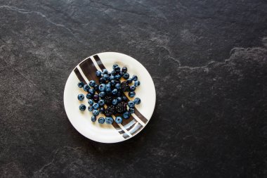 Taze yaban mersini ve blackberry taş zemin, organik siyah plaka üzerine berry, superfood ve kavram detoks. Düz yatıyordu stil, üstten görünüm