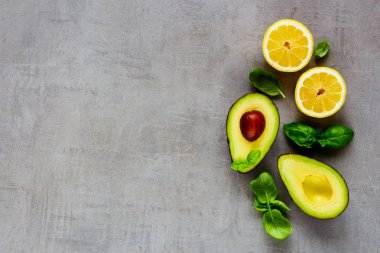 Limon ve açık renkli düz-lay üzerinde fesleğen taze avokado. Üstten görünüm, kopya alanı.