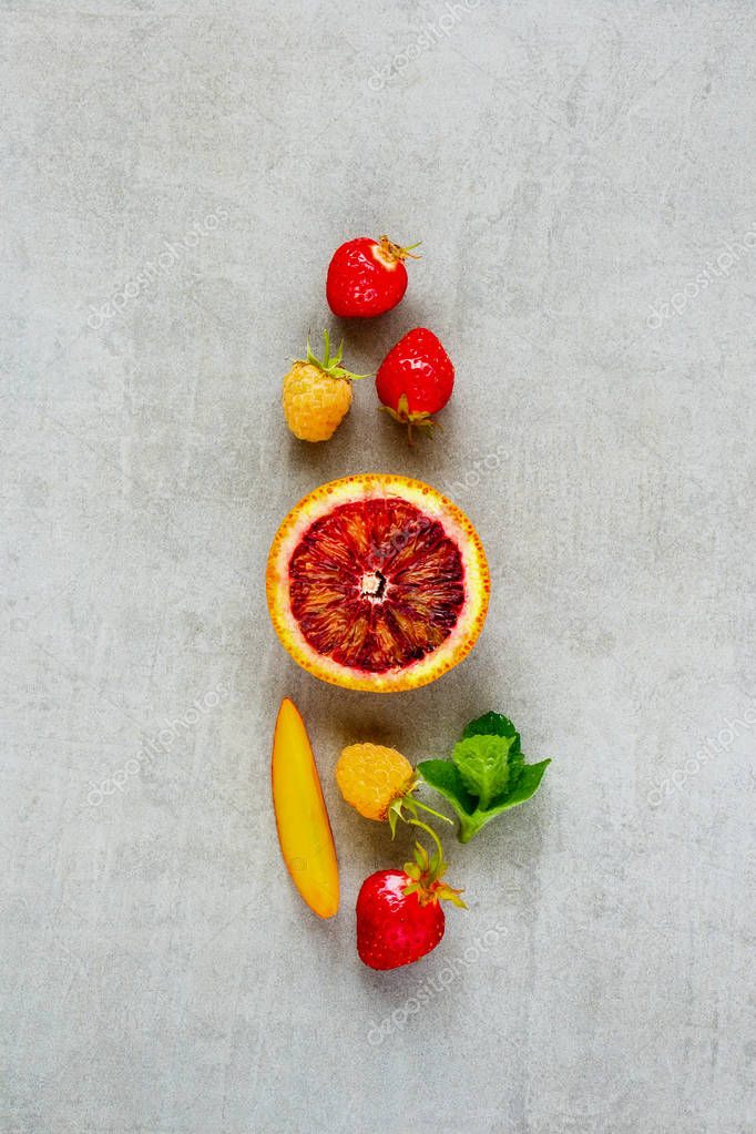 Flat-lay of resh fruits and berries on light background. Food concept. Top view