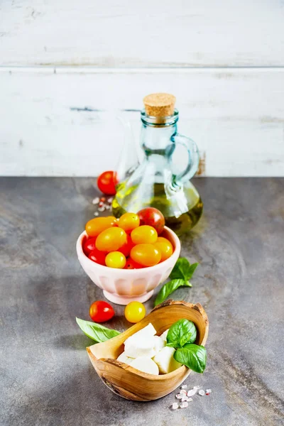Fresh italian salad ingredients. Mediterranean salad. Italian cuisine. Mediterranean cuisine. Tomato mozzarella basil leaves and olive oil
