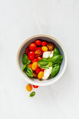 Tabak caprese salatası kapatın. Domates mozzarella fesleğen yaprağı düz yatıyordu. İtalyan mutfağı. Akdeniz mutfağı.