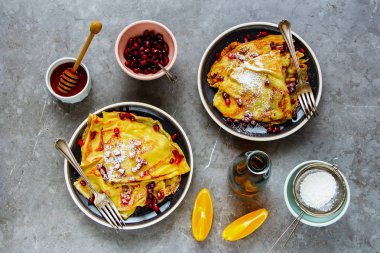 Ev yapımı krep nar ile tepesinde. Düz-lay ince krep, meyve, bal ve akçaağaç şurubu