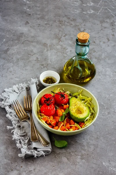Vegan dinner bowl close up. Fresh salad, avocado half, grains, beans, roasted vegetables. Superfood, clean eating, dieting food concept - Image