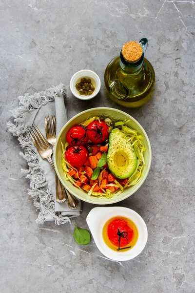 Vegan dinner bowl flat lay. Fresh salad, avocado half, grains, beans, roasted vegetables, top view. Superfood, clean eating, dieting food concept - Image