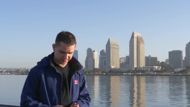 Young man makes selfie on background of downtown — Stock Video