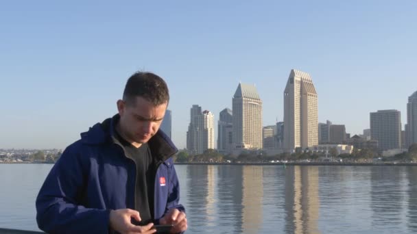 Young man shows a peace sign and makes a selfie — Stock Video