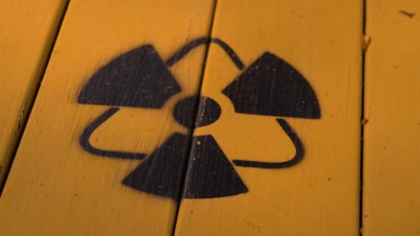 Sign of radiation on a yellow wooden board. — Stock Video