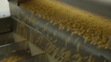 Çiğ spagetti bir konveyör üzerinde hareket ediyor