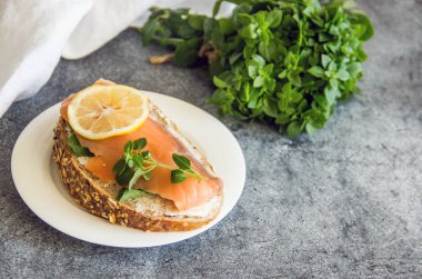 Sandviç somon ve taş zemin üzerine limon ile