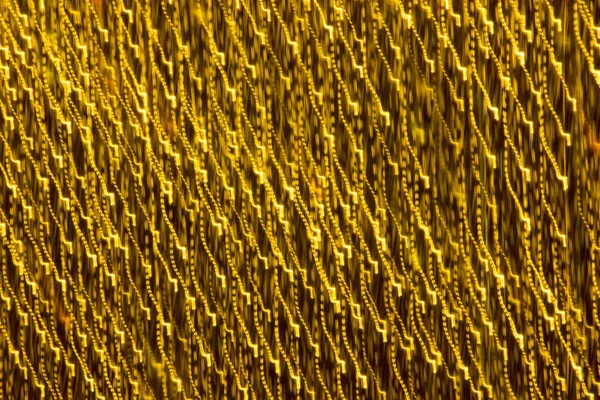 Abstract xmas Gold sparkles or glitter lights. Christmas festive gold background. Defocused bokeh particles. Template for design