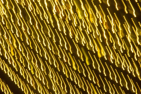 クリスマスを抽象的なゴールドの輝きやきらめき クリスマスお祝い金の背景色 ボケ粒子をデフォーカスしました デザイン用テンプレート — ストック写真