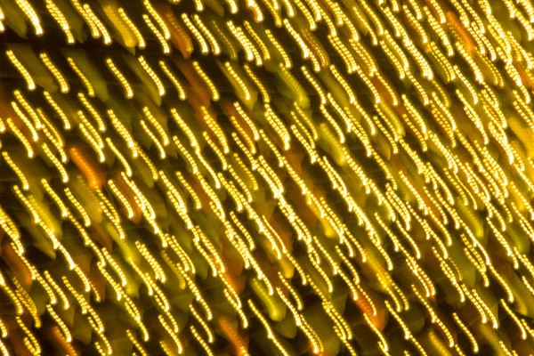 Abstract xmas Gold sparkles or glitter lights. Christmas festive gold background. Defocused bokeh particles. Template for design