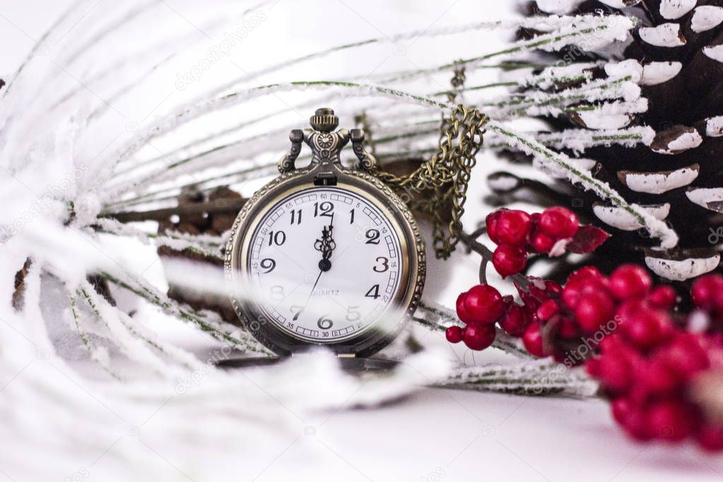 Vintage pocket watch showing five to twelve  with Christmas twigs and golden decorations, space for your text