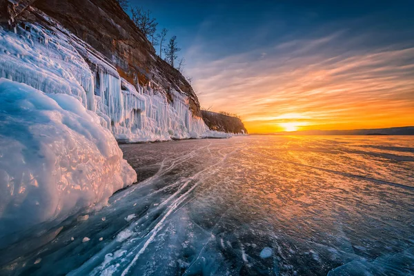 Zachód słońca niebo z naturalnym przełamaniem lodu nad zamarzniętą wodą nad jeziorem Bajkał, Syberia, Rosja. — Zdjęcie stockowe