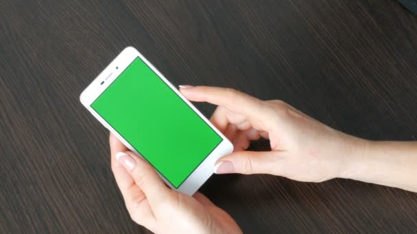 Les mains féminines avec une belle manucure française prennent un smartphone blanc avec écran vert. Utilisation de Smartphone, tenant Smartphone avec écran vert — Video