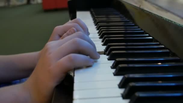 Hands teenage boy playing piano keys close up view — Stock Video