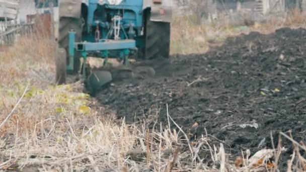 4 밭 고 랑 쟁기 분야 검은 흙을 plowing 블루 트랙터 가까이 보기 — 비디오