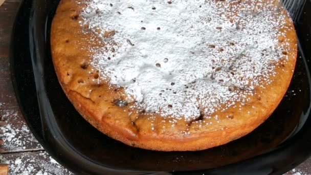 Icing sugar generously sprinkles homemade freshly baked cake with cherry — Stock Video