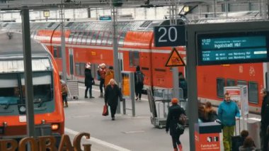 Münih, Almanya - 2 Aralık 2018: Turist yolcu yürüyüş boyunca modern kırmızı tren ana tren istasyonunun yanındaki platformu