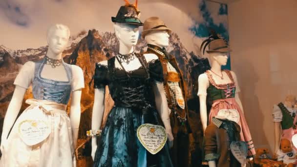 Beautiful various womens national Bavarian costumes dirndl on shop window — Stock Video