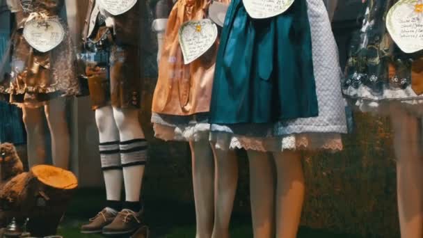 Beautiful various womens national Bavarian costumes dirndl on shop window — Stock Video