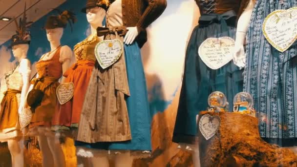 Beautiful various womens national Bavarian costumes dirndl on shop window — Stock Video