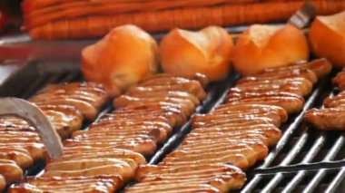 Kadınlar çok lezzetli taze Alman sosis ızgara. Nürnberg sosis taze çörek yakınındaki çok sayıda Noel gıda piyasada hazır mısın
