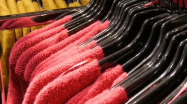 Çeşitli şık örme çok renkli kazak moda siyah askı bir giyim mağazasında alışveriş merkezi veya alışveriş merkezi içinde asılı