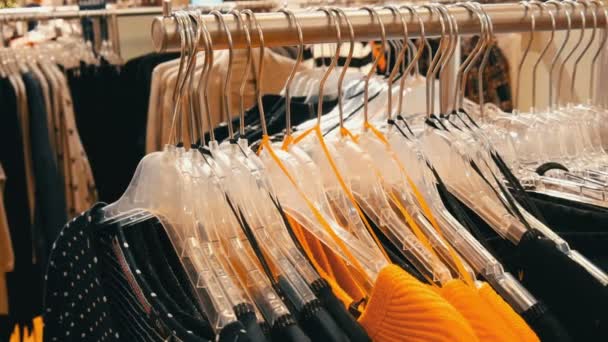 Nuremberg, Germany - December 3, 2018: Stylish clothes hanging in row on hangers in a clothing store in a mall. — Stock Video