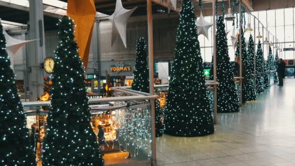 Mnichov, Německo - 2. prosince 2018: Nádraží před Vánocemi. Krásně zdobené vánoční stanice. Velké zlaté a stříbrné vánoční hvězdy na strop pohled shora, zdobené vánoční stromky — Stock video