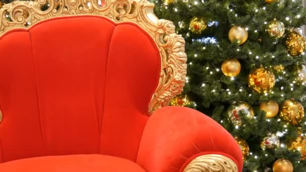 Red chair of Santa Claus or St. Nicholas near christmas tree at the mall. Christmas decor shopping center — Stock Video