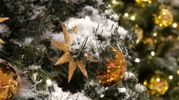 Various Christmas and New Years toys, balls and decorations on a Christmas tree close up view. Preparation for the holiday — Stock Video