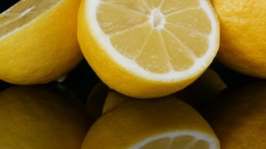 Siyah arka planda siyah ayna yüzeyinde büyük taze sarı limon görünümü yakın.